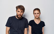© SHOTPRIME STUDIO - cheerful man and woman in black t-shirts studio casual clothes isolated background