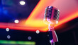 © Parilov - Close-up retro vintage microphone on blurred stand up background, concert in nightclub