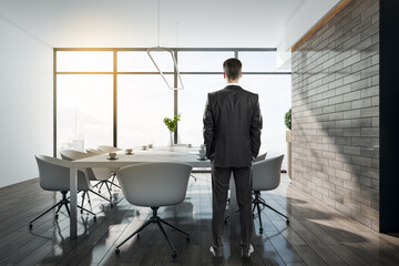 Poster - Young businessman standing in conference interior