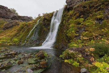  Gjain waterfall at small valley Gjain with its small waterfalls, ponds, and volcanic structures in the south of Iceland, about half an hour walking distance from the historical farm Stöng.