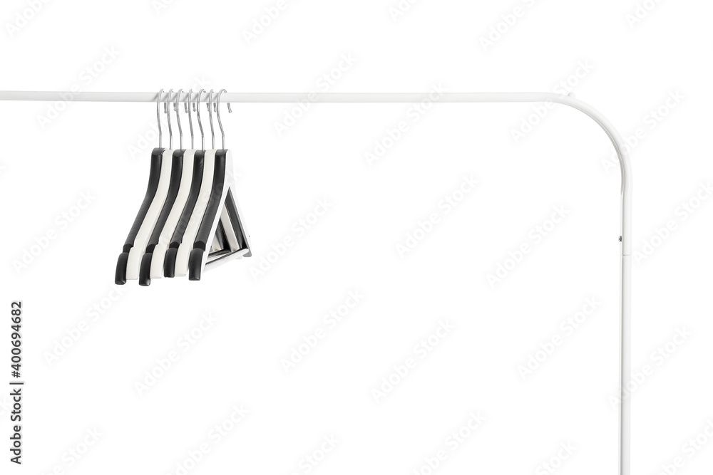 Rack with clothes hangers on white background