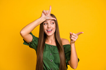 Sticker - Portrait of attractive cheerful brown-haired girl bullying you fool isolated over bright yellow color background