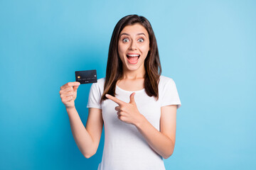 Wall Mural - photo of young happy crazy excited smiling positive girl pointing finger at credit card isolated on 