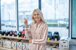 © zinkevych - Blonde female customer standing in a consumer goods showroom and smiling