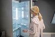 © zinkevych - Blonde female customer choosing a fridge in a megastore