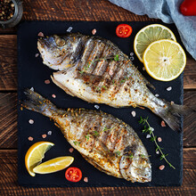 Grilled Dorado Fish On Wooden Background. Roasted Seafish With Spice And Herbs