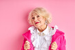 © alfa27 - fancy aged lady posing at camera wearing pink coat and white blouse isolated over pink background