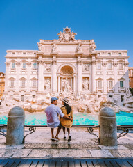 young couple mid age on a city trip in Rome Italy Europe, couple sightseeing visit Fontana di Trevi in Rome Italy