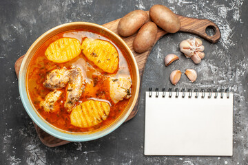 Wall Mural - Top above view of bony chicken soup foods and notebook