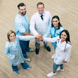 © My Ocean studio - Top view full-length photo of happy successful medics team while conversation at the hospital