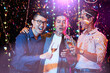 © DragonImages - Cheerful hugging male friends drinking champagne under falling confetti when having bachelor party in night club