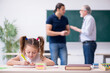 © Elnur - Young parent, old male teacher and little girl in the classroom