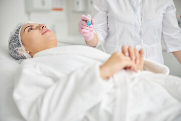 Young woman undergoing a facial hydrodermabrasion treatment