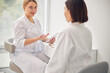 © Svitlana - Certified dermatologist consulting her dark-haired woman client