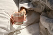 © Iuliia Pilipeichenko - A glass of water next to a girl sleeping in bed. Happy morning. Woman in pyjamas. Healthy lifestyle, wellness. Proper nutrition. Drinking water. Morning with water. Sunlight on linens. Pillow, blanket