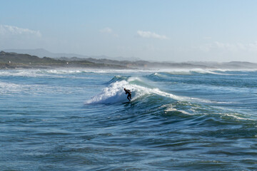 surfer enjoying a surf session at Sao Torpes Beach in Sines on the Alentejo Coast