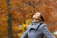 Middle Age Female Breathing Fresh Air In A Forest In Fall