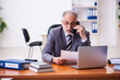 © Elnur - Old male businessman employee reading contract in the office