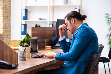 Young male employee working in the office