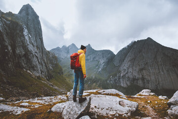 Wall Mural - Man with backpack hiking solo in Norway mountains travel vacations outdoor adventure trekking active healthy lifestyle weekend getaway