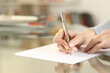 © PheelingsMedia - Woman hands writing letter on paper sheet on table