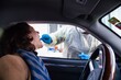 © Nektarstock - Woman Receiving Coronavirus Swab Test Inside Car