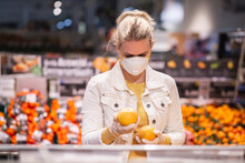 Teenage Girl Wearing Protectice Mask And Gloves Choosing Fruits At Supermarket