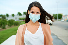 Young Woman Wearing Protective Face Mask Standing On Street