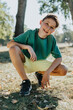 © Mareen Fischinger/Westend61 - Boy crouching in pubic park on sunny day