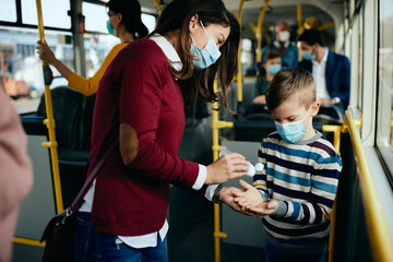 Wall Mural - Hand disinfection in a public transport!