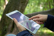 © Maria Maar/Westend61 - Mature man using digital tablet while sitting in nature