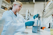 © Mareen Fischinger/Westend61 - Female scientist removing microscope slide while standing at laboratory