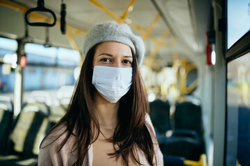 Wall Mural - Female commuter wearing protective face mas in a public transport.