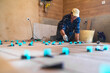 © SERGIO NIEVAS/Westend61 - Mature man working on parquet floor in house