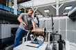 © Daniel Ingold/Westend61 - Manual worker tightening bolt of machine while standing at factory