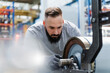 © Daniel Ingold/Westend61 - Mid adult male technician concentrating while analyzing machine part at factory