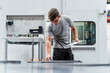 © Daniel Ingold/Westend61 - Male engineer holding clipboard while examining machinery in industry
