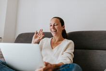 Happy Woman Waving Hand Video Call On Laptop At Home