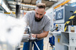 © Daniel Ingold/Westend61 - Bearded male technician analyzing machine in industrial factory