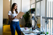 © Giorgio Fochesato/Westend61 - Smiling businesswoman holding clipboard while looking away in office