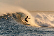 © Konstantin Trubavin/Westend61 - Mid adult man surfing on sea during sunset