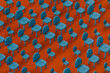 © Giada Canu/Westend61 - Rows of blue empty chairs on red background