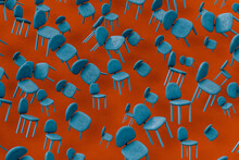 Rows Of Blue Empty Chairs Floating Against Red Background