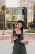 © VITTA GALLERY/Westend61 - Barcelona, Spain. Young indian business woman outdoors on business district. Business, woman, job, break, formal, youg, working, etrepreneur, millenial, beautiful,