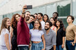 © Eugenio Marongiu/Westend61 - Man taking selfie with group of friends in city