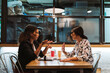 © Mikel Taboada/Westend61 - Female business colleagues discussing while sitting at cafe