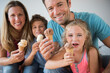 © Jamie Grill/Tetra Images - Family with two children (6-7, 8-9) holding ice cream cones