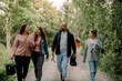 © Maskot - Smiling daughters with father and mother on footpath during vacations