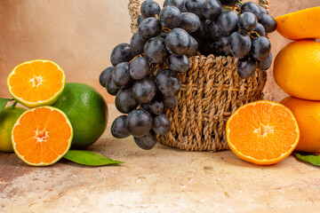 front view fresh black grapes with orange on light background fruit mellow photo vitamine tree ripe