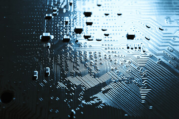 Blue electronic mother board circuit close up macro background.